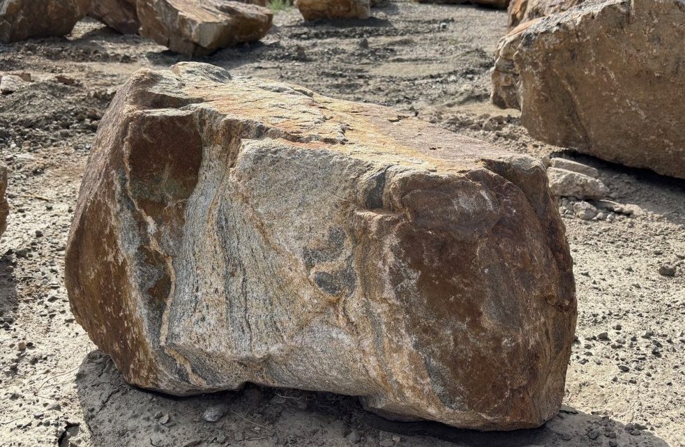 Colorado Sunset boulder — warm tan, rust and grey natural granite