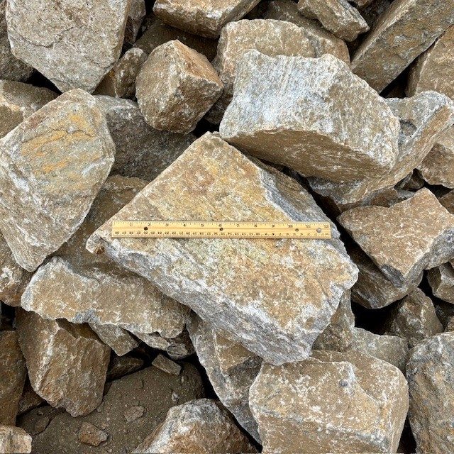 Colorado Sunset rip rap — large angular tan and grey rock for erosion control